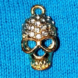 Rhinestone and gold tone skull pendant